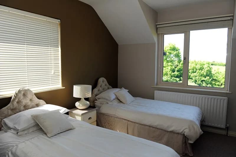Room 2, a twin room with two single beds and a window over the fields