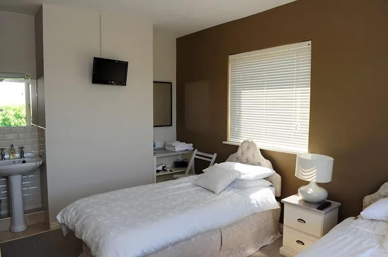 Room 2 from the doorway, showing the washbasin and wall mounted television