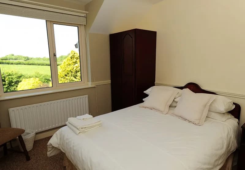 Room 5, a cosy double room with a wardrobe and a window over the fields